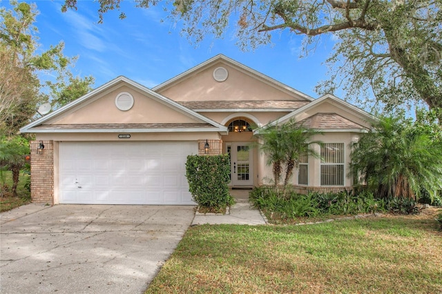 view of front facade with a front yard and a garage