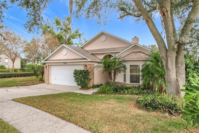 view of front facade with a garage and a front yard