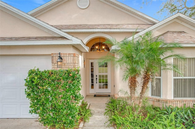 doorway to property with a garage