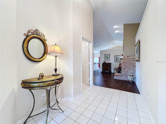 hall with light hardwood / wood-style floors and lofted ceiling