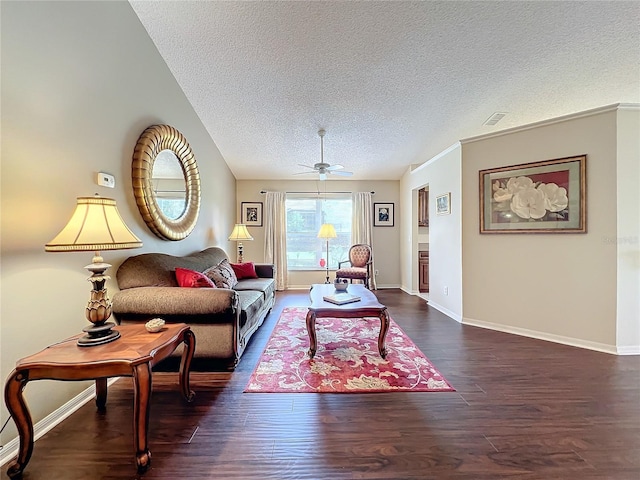 living room with a textured ceiling, dark hardwood / wood-style flooring, and ceiling fan