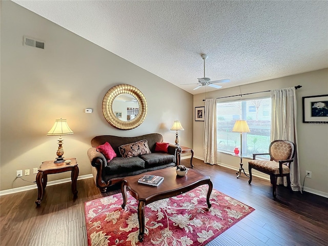 living room featuring a textured ceiling, lofted ceiling, ceiling fan, and dark hardwood / wood-style floors