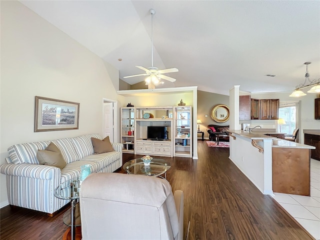 living room featuring ceiling fan, dark hardwood / wood-style flooring, sink, and high vaulted ceiling