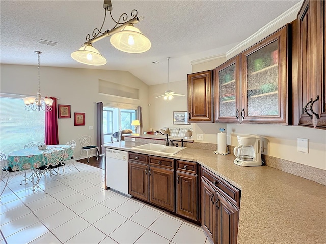 kitchen with white dishwasher, sink, hanging light fixtures, vaulted ceiling, and light tile patterned floors