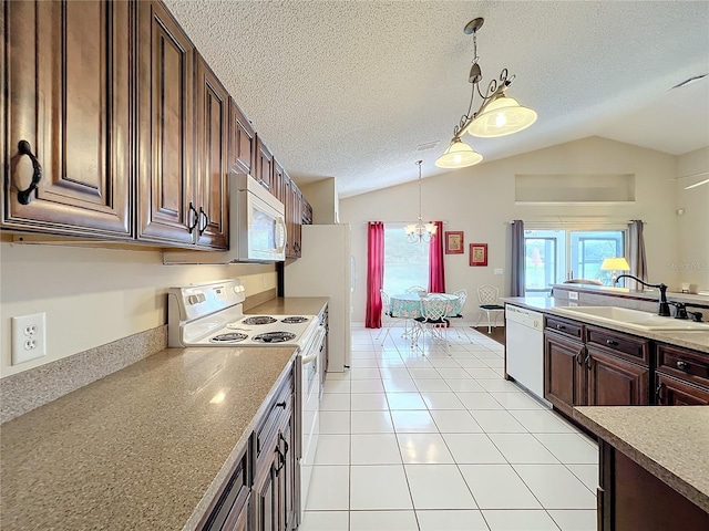 kitchen featuring white appliances, sink, light tile patterned floors, hanging light fixtures, and lofted ceiling