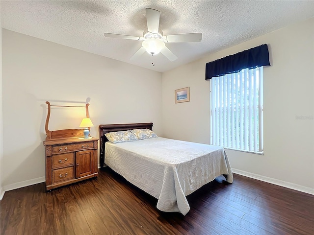 bedroom with ceiling fan, dark hardwood / wood-style flooring, and a textured ceiling