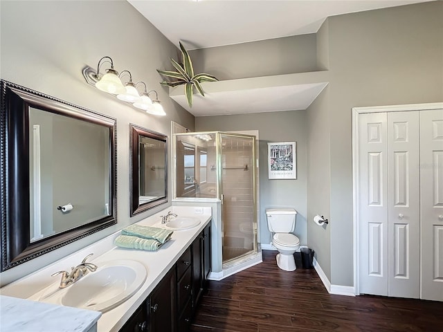 bathroom featuring hardwood / wood-style floors, vanity, toilet, and walk in shower