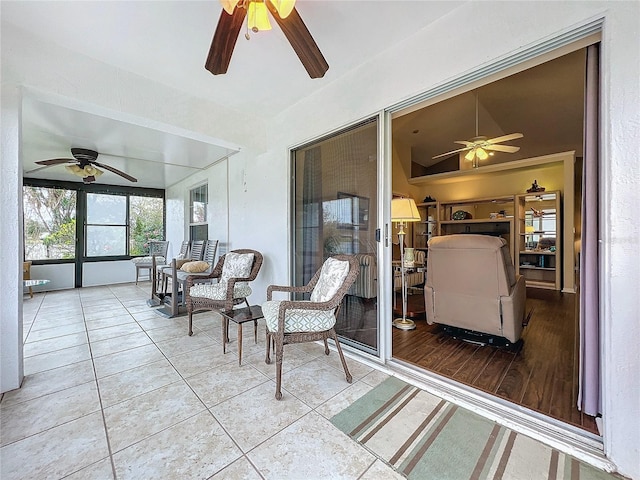 sunroom / solarium featuring ceiling fan and lofted ceiling