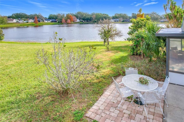 view of yard featuring a water view and a patio area