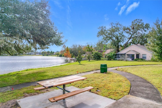 view of community with a water view and a lawn