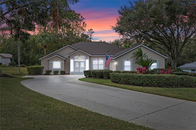 ranch-style house featuring a yard