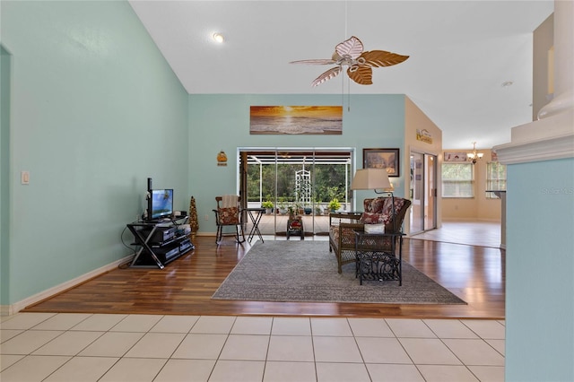 living room featuring light hardwood / wood-style floors, high vaulted ceiling, and ceiling fan