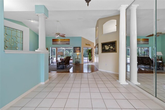 tiled entrance foyer with ceiling fan, french doors, and vaulted ceiling