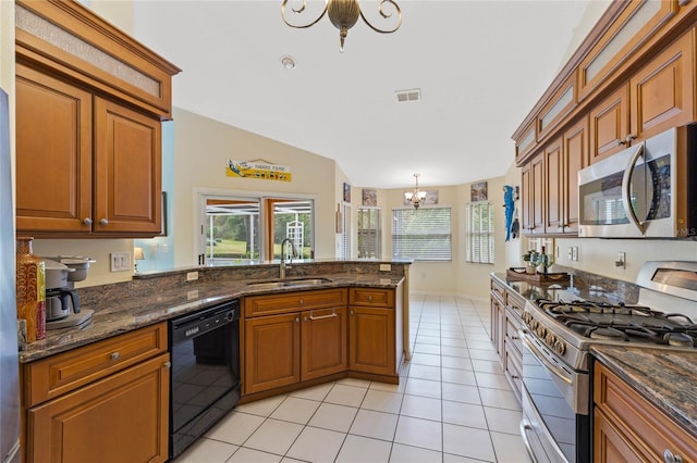 kitchen with pendant lighting, sink, a notable chandelier, light tile patterned flooring, and stainless steel appliances