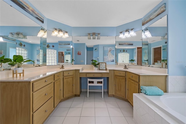 bathroom with tile patterned floors, vanity, and a relaxing tiled tub