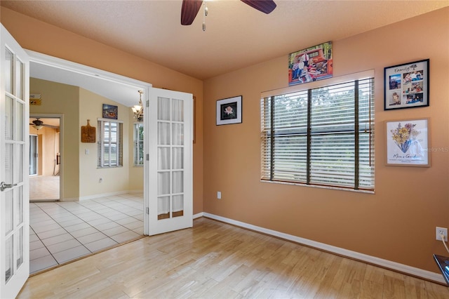 unfurnished room with french doors, light hardwood / wood-style flooring, and a healthy amount of sunlight