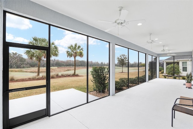 unfurnished sunroom with a healthy amount of sunlight and ceiling fan