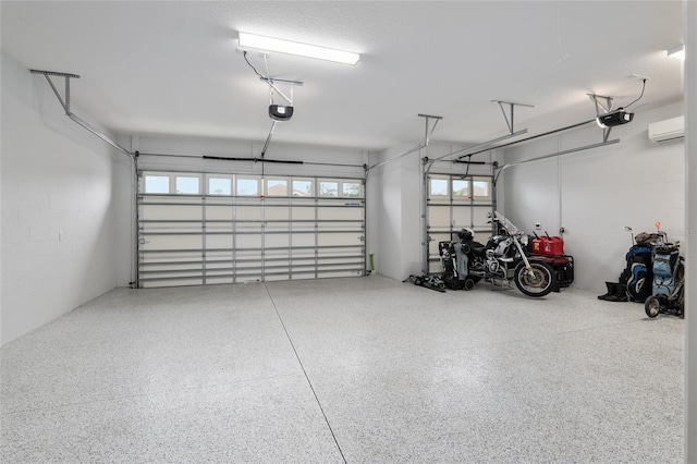 garage featuring a garage door opener and a wall mounted air conditioner