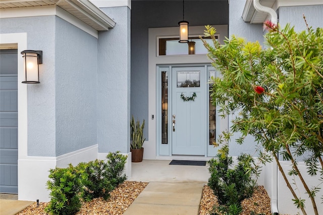 property entrance with stucco siding