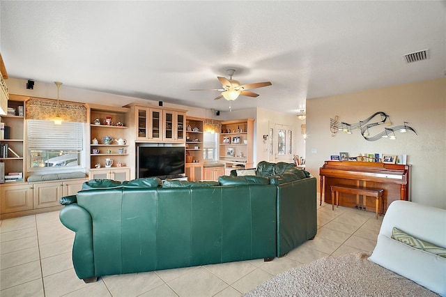 living room with ceiling fan and light tile patterned flooring