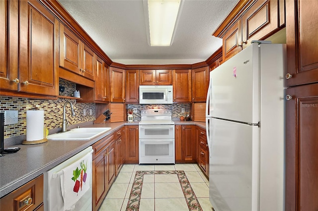 kitchen featuring sink, tasteful backsplash, a textured ceiling, white appliances, and light tile patterned floors