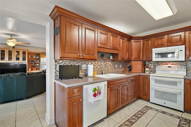 kitchen featuring white appliances, a textured ceiling, ceiling fan, sink, and light tile patterned floors