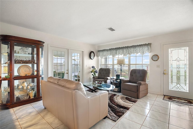 tiled living room with a wealth of natural light and french doors