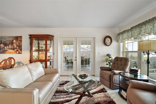 living room featuring french doors, light tile patterned floors, and a wealth of natural light