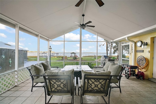 sunroom / solarium featuring a water view, vaulted ceiling, and ceiling fan