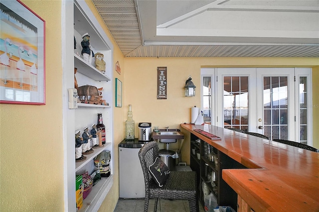 interior space with french doors and refrigerator