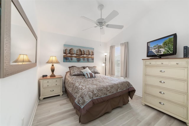 bedroom with ceiling fan, light hardwood / wood-style flooring, and lofted ceiling