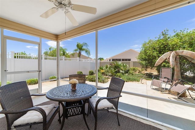 sunroom featuring ceiling fan