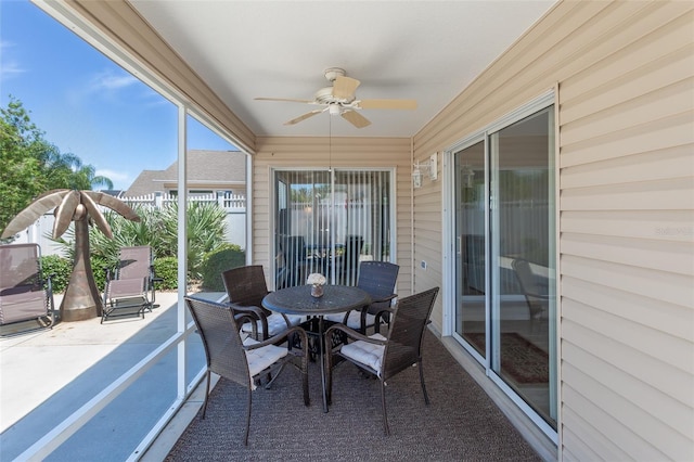 sunroom featuring ceiling fan