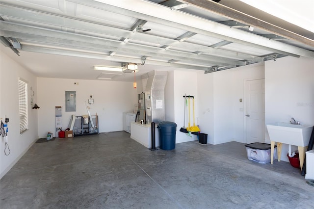 garage with washer and clothes dryer, a garage door opener, and electric panel