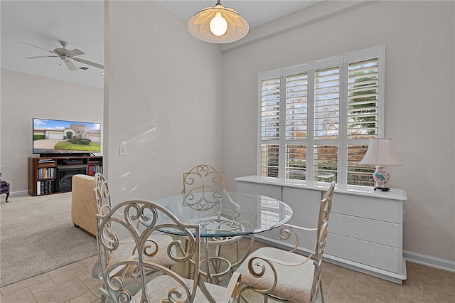 dining room featuring ceiling fan and light carpet