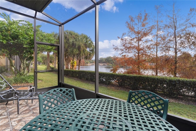 unfurnished sunroom with a water view