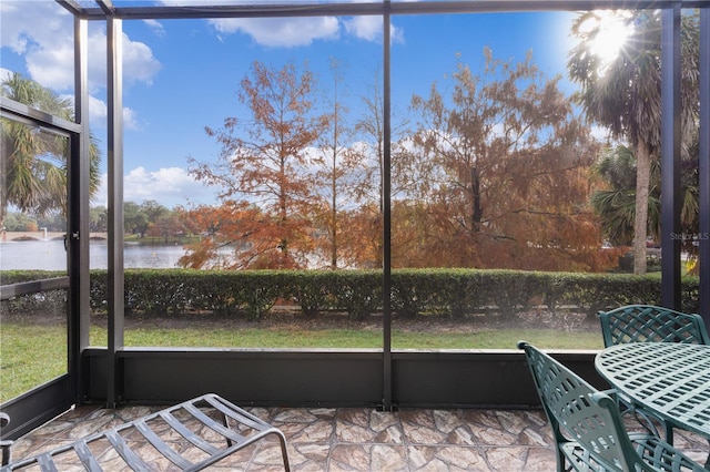 unfurnished sunroom with a water view