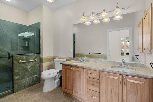 bathroom with walk in shower, vanity, toilet, and tile walls