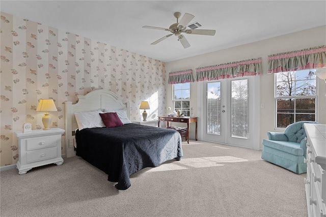 carpeted bedroom featuring access to exterior, multiple windows, and ceiling fan