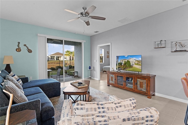 living room with ceiling fan and light tile patterned floors