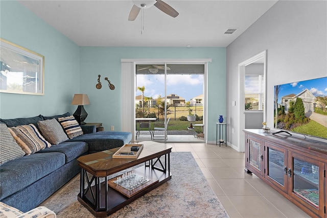 tiled living room featuring ceiling fan