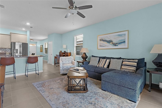 living room with ceiling fan and light tile patterned floors