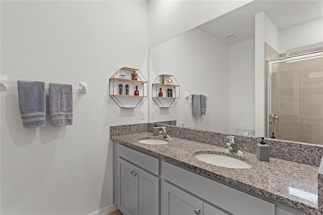 bathroom featuring an enclosed shower, vanity, and toilet