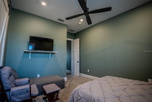 carpeted bedroom featuring ceiling fan and a textured ceiling