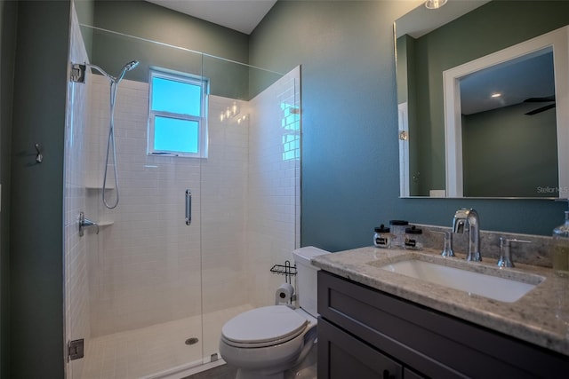 bathroom with vanity, a shower with shower door, and toilet