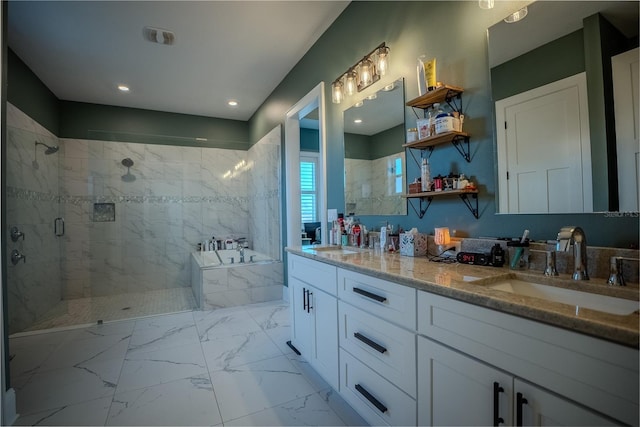 bathroom featuring shower with separate bathtub and vanity