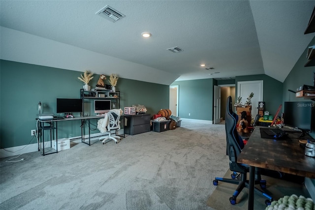 carpeted office space featuring lofted ceiling