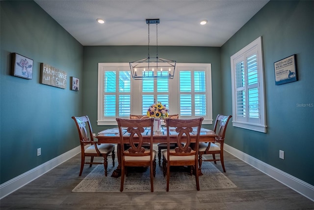 dining room featuring dark hardwood / wood-style floors and an inviting chandelier