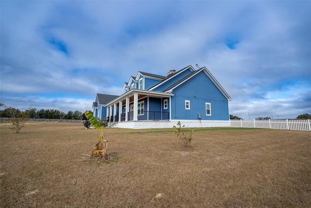 exterior space featuring a lawn and covered porch