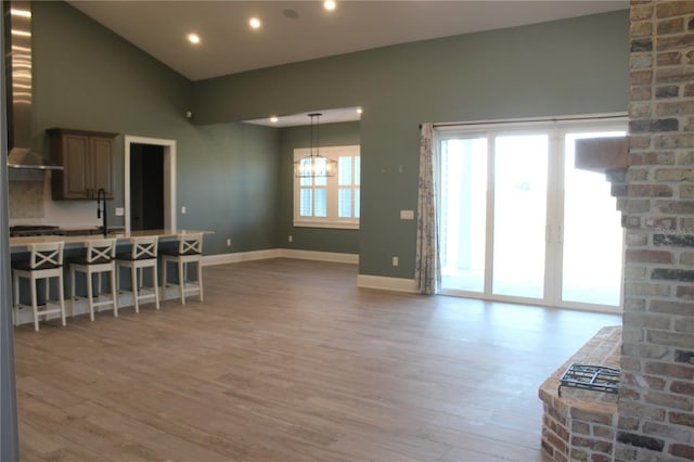 2437 Bay Lake Loop, Groveland, FL 34736 - living area featuring light wood-style floors, baseboards, recessed lighting, and lofted ceiling
